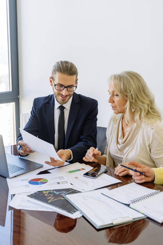 pexels photo 5816300 5816300 Two business professionals reviewing financial documents and graphs during a meeting.